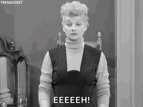 A black-and-white woman stares ahead with the caption “EEEEH!”