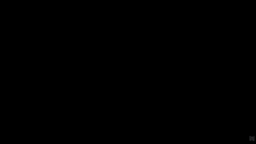 a dark room with a purple light shining on a screen