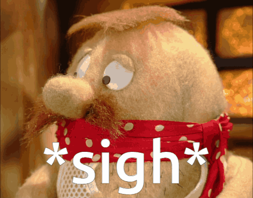 a stuffed animal with a red scarf around its neck has the word sigh written on it