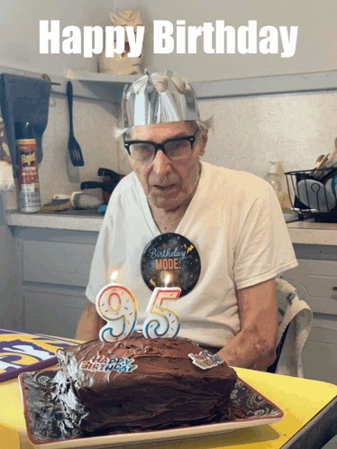 an elderly man celebrates his 95th birthday by blowing out a candle