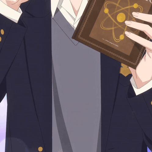a man in a suit holds a book with an atom on the cover