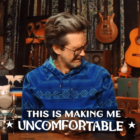 Link Neal looks down uneasily at a table of guitars with the caption “THIS IS MAKING ME UNCOMFORTABLE.”