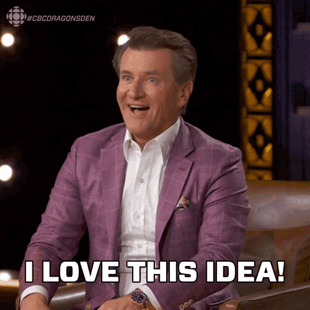 a man in a purple suit is sitting in a chair and says i love this idea