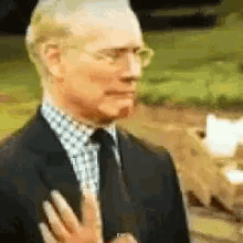 A man in a suit looks disgusted and pulls back slightly.
