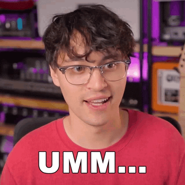 a man wearing glasses and a red shirt says umm ...