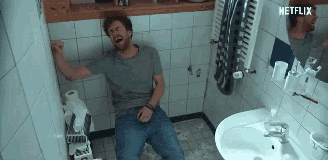 a man is sitting on a toilet with a netflix logo on the bottom
