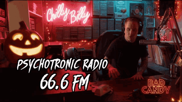 a man sitting in front of a neon sign that says chilly billy psychotronic radio 66.6 fm