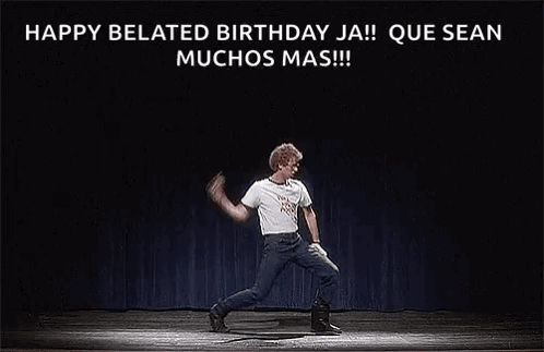 a man is dancing on a stage with the words `` happy belated birthday ja ! ''