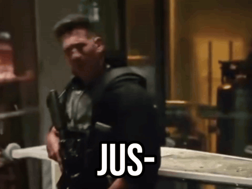 a man is holding a gun and says jus