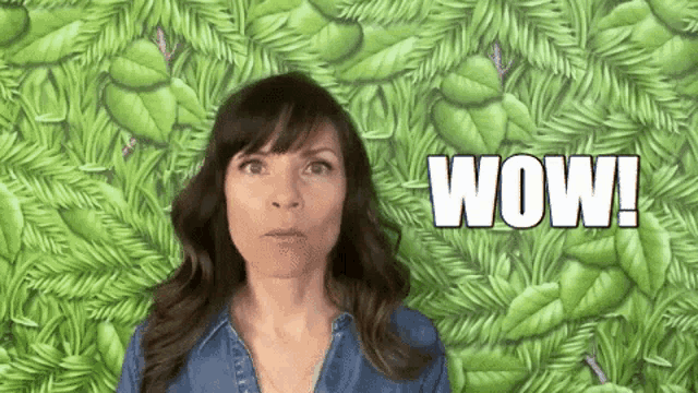 a woman is making a surprised face in front of a green background with the words wow written on it .