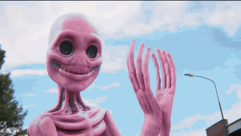 a pink alien with a smile on its face
