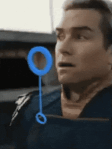 a close up of a man 's face with a blue circle around it