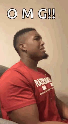 A man in a red shirt looks upward beneath “O M G!!”.