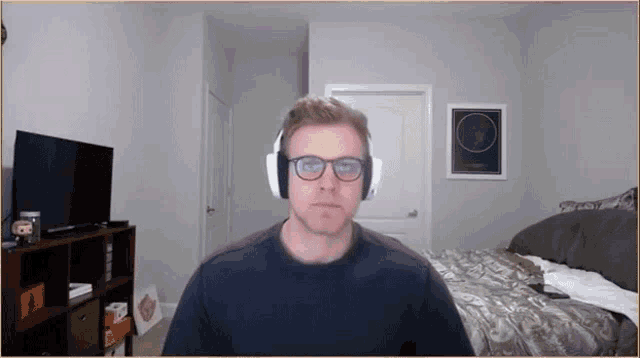 a man wearing glasses and headphones is looking at the camera