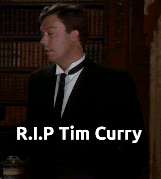 a man in a suit and tie is standing in front of a bookshelf with the words r.i.p tim curry above him