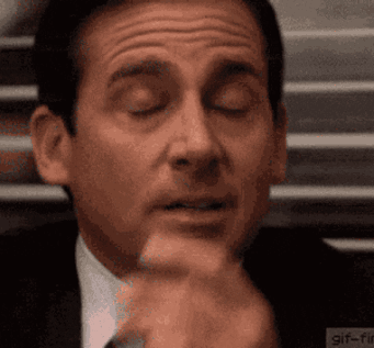 a close up of a man 's face with his eyes closed and his hand on his chin .