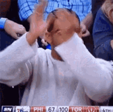Sports fan claps excitedly from the crowd.