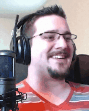 a man wearing headphones and glasses is smiling
