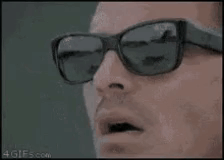 A face wearing dark sunglasses reacts with an open-mouthed “wow” look.