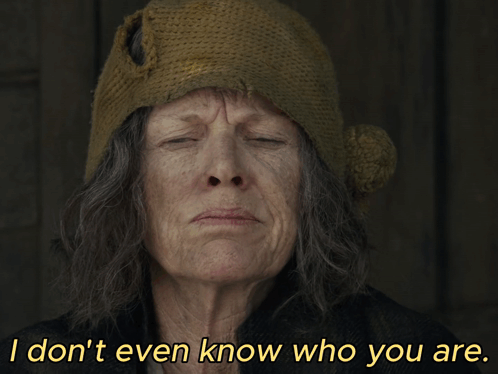 an older woman wearing a knitted hat says i don 't even know who you are