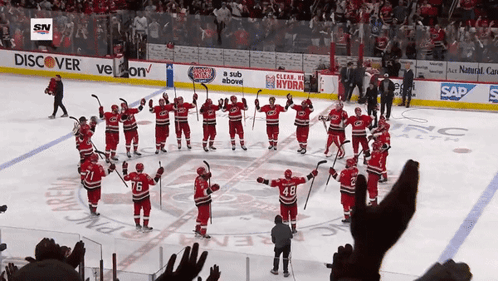 hockey players on the ice in front of a banner that says discover