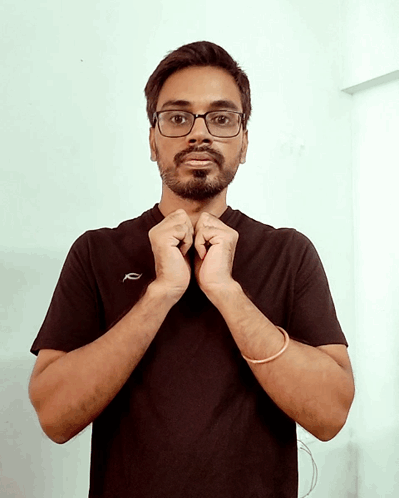 a man wearing glasses and a black t-shirt with the letter r on it