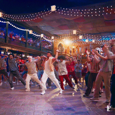 a group of people are dancing in front of a sign that says l.