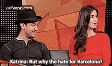 a man and a woman are sitting next to each other on a couch and talking about barcelona .
