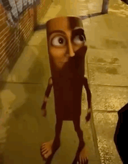 A stylized brown cartoon creature stands alone in a dim alley.