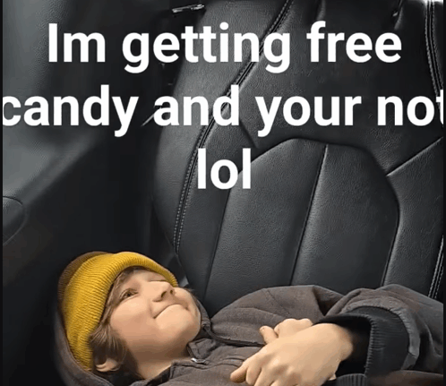 a child is laying in the back seat of a car with the words im getting free candy and your not lol written above him