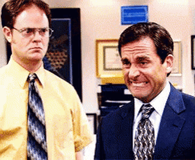 Dwight Schrute and Michael Scott make a painfully awkward face in The Office.