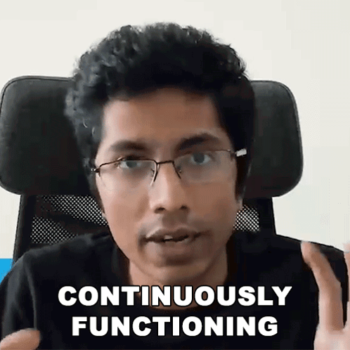 a man wearing glasses is sitting in a chair and saying continuous functioning