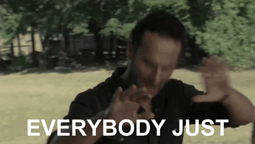 a man in a black shirt says everybody just in white letters