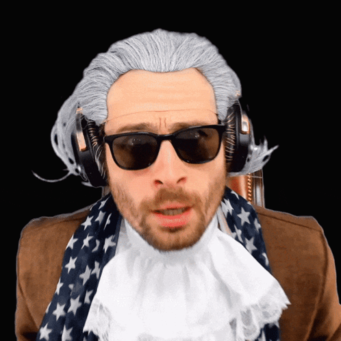 Ben Jammins in sunglasses and headphones looks toward the camera with a disgusted reaction.