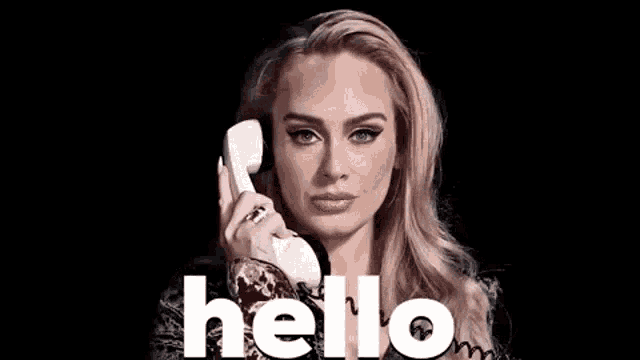 Adele holds a phone beside large “hello” text.