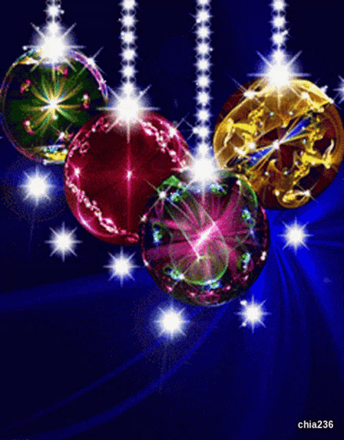 colorful christmas balls hanging from strings on a blue background with chia236 written on the bottom