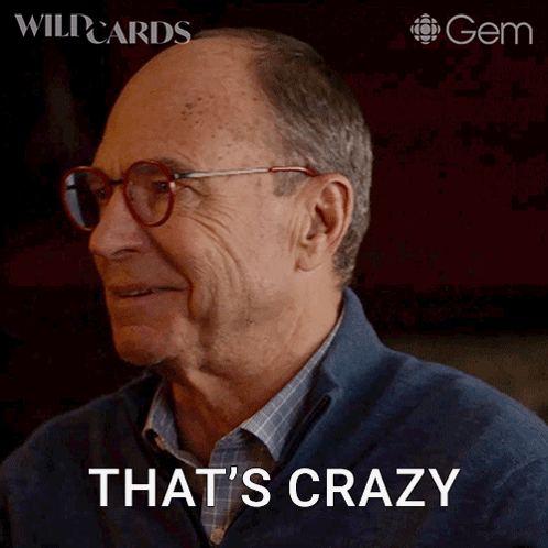 a man wearing glasses says that 's crazy on a screen