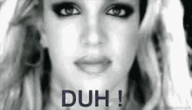Britney Spears appears in a black-and-white close-up beneath “DUH!”.