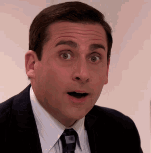 Michael Scott stares wide-eyed in surprise.