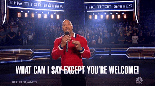 The Rock speaks onstage beneath the lyric “WHAT CAN I SAY EXCEPT YOU’RE WELCOME.”