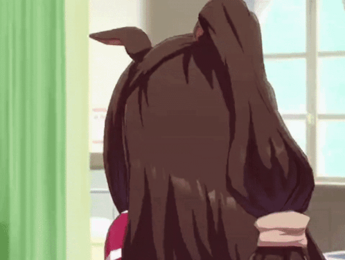 a close up of a person 's head with a green curtain in the background