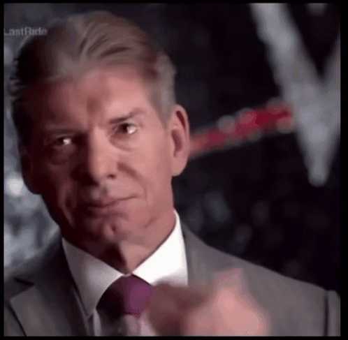 Vince McMahon looks emotional and wipes away a tear.