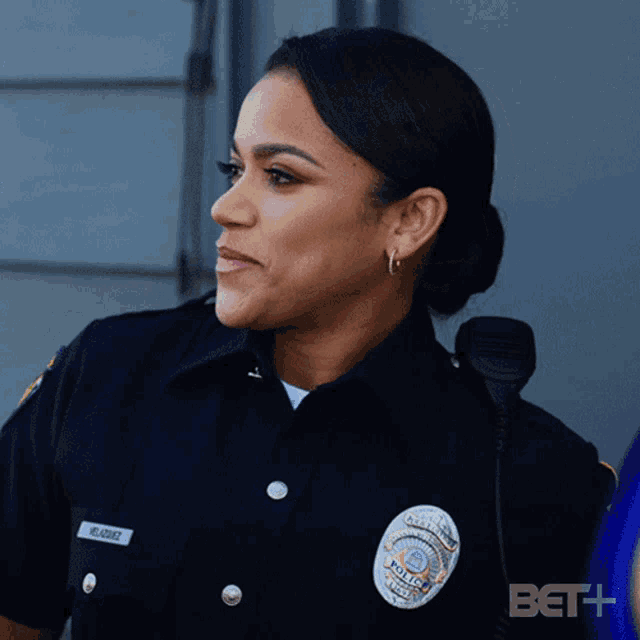 a woman in a police uniform has the name mc alvarez on her badge