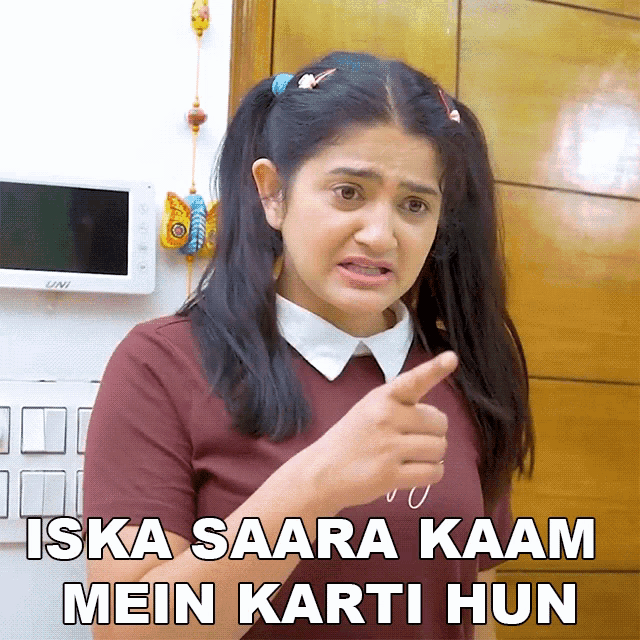 a girl with pigtails is pointing at the camera with the words iska saara kaan mein karti hun below her