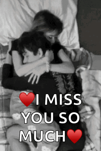 A black-and-white couple cuddle in bed with “I MISS YOU SO MUCH” text.