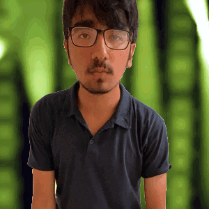 a man wearing glasses and a blue shirt is looking at the camera