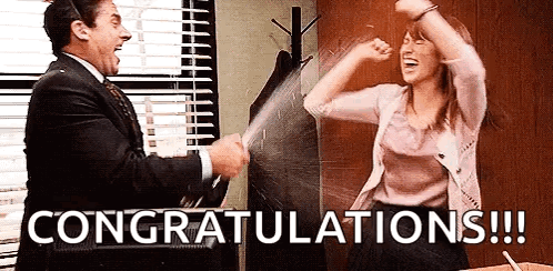 Michael Scott and Erin Hannon from The Office celebrate with raised glasses as “CONGRATULATIONS!!!” appears.