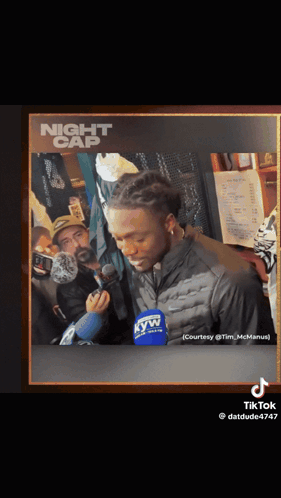 a picture of a man talking into a microphone with night cap written on the top