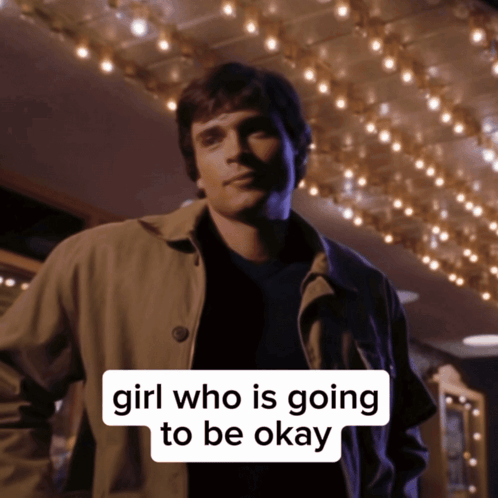 a man in a trench coat stands in front of a sign that says girl who is going to be ok
