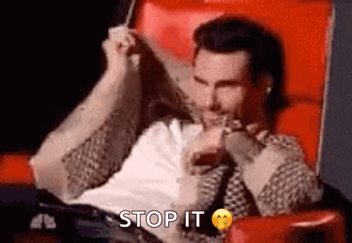 Man covers his blushing face with both hands beside “STOP IT.”